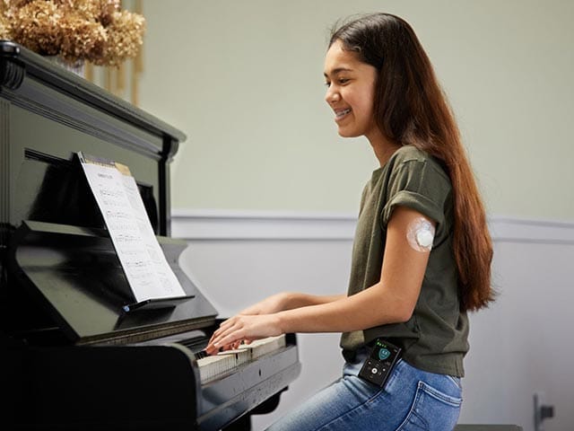 Guardian 4 sensor on girls's arm playing piano