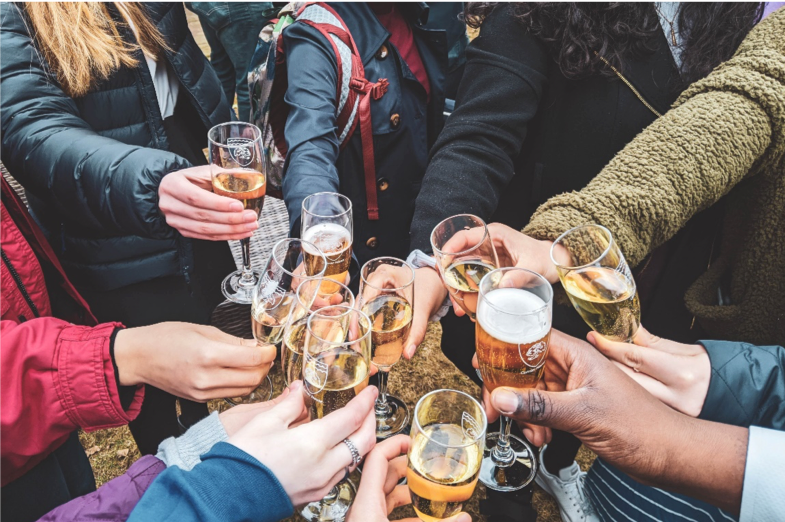 partygoers toasting with drinks