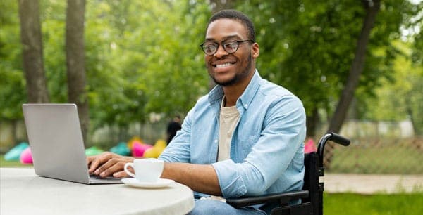 Photo of a man using a laptop