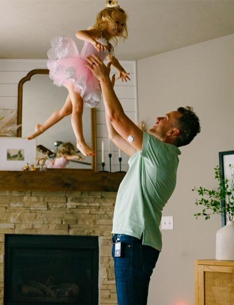 Man holding up daughter above his head