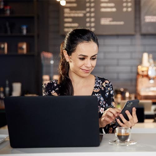 Woman with laptop on phone