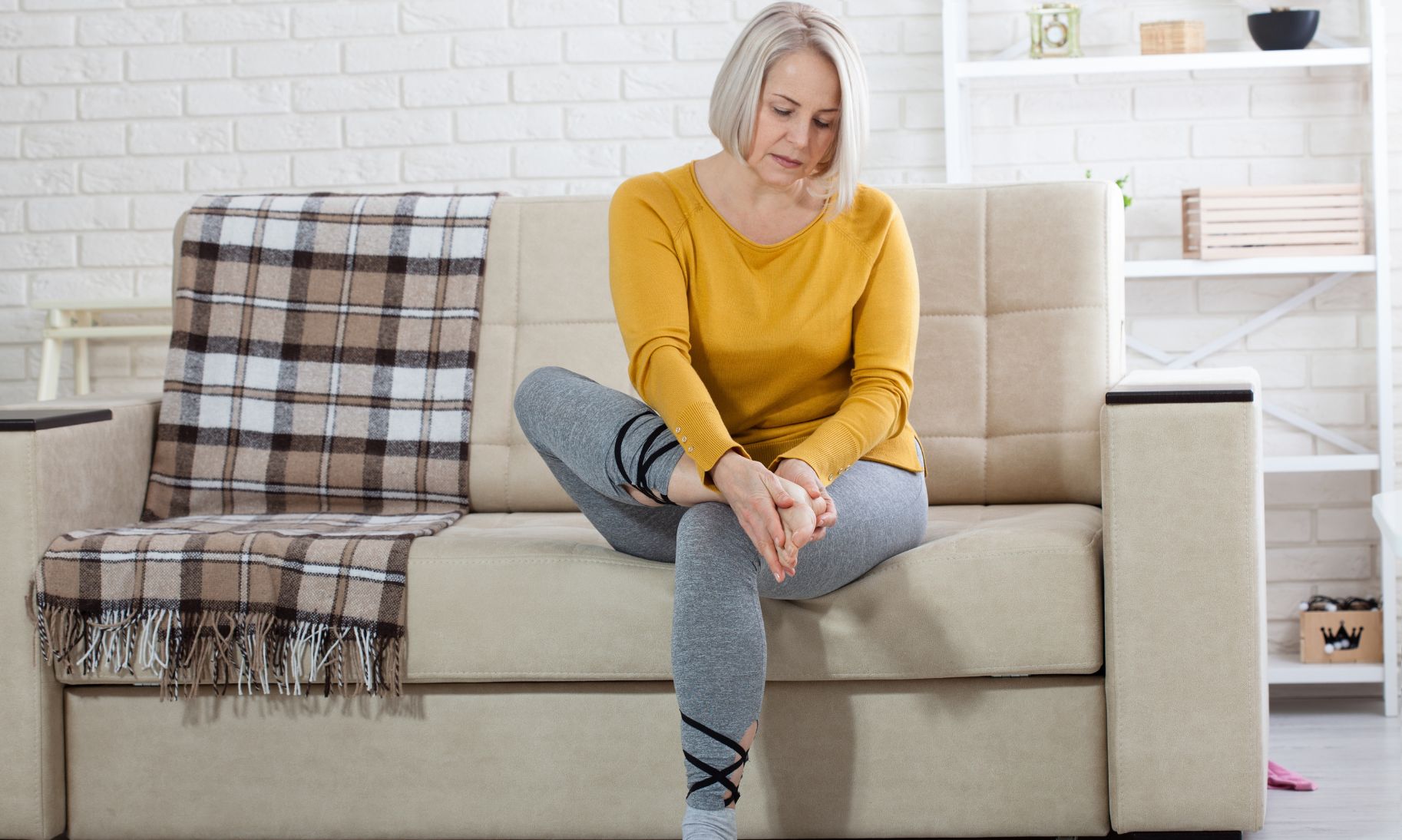 Older woman holding her foot