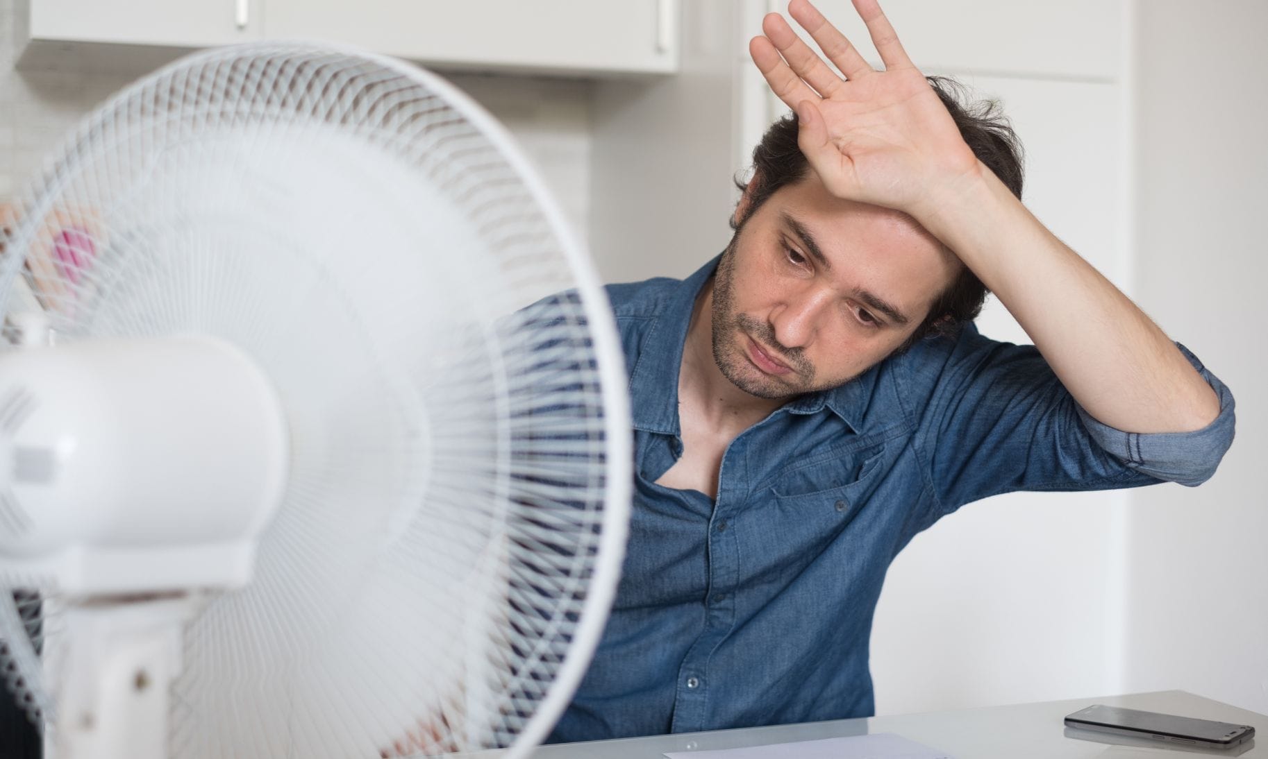 man in front of a fan