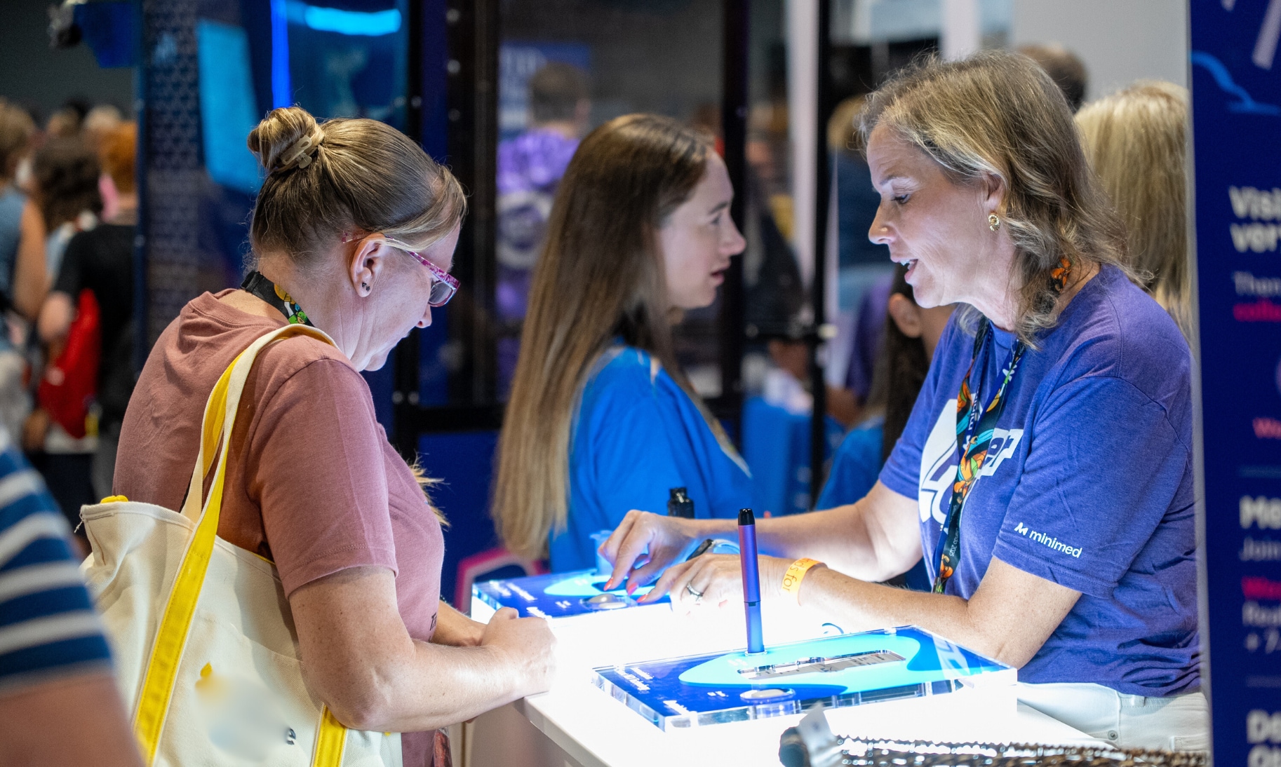 Women at a conference booth talking