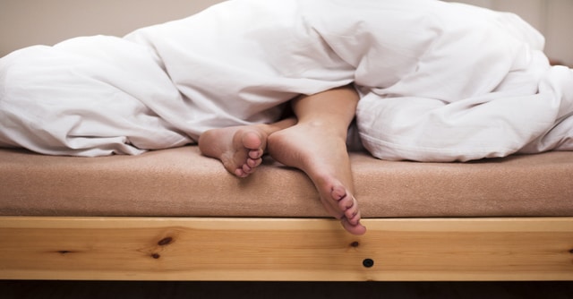 Feet sticking out of bed