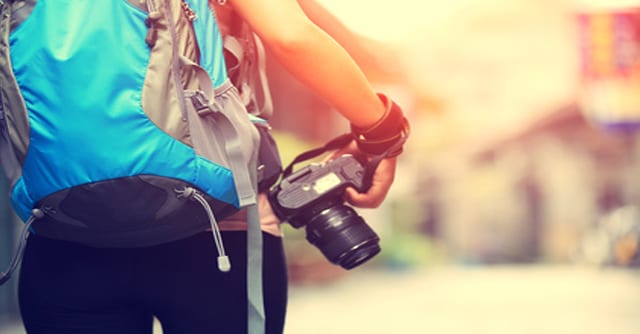 girl with backpack and camera