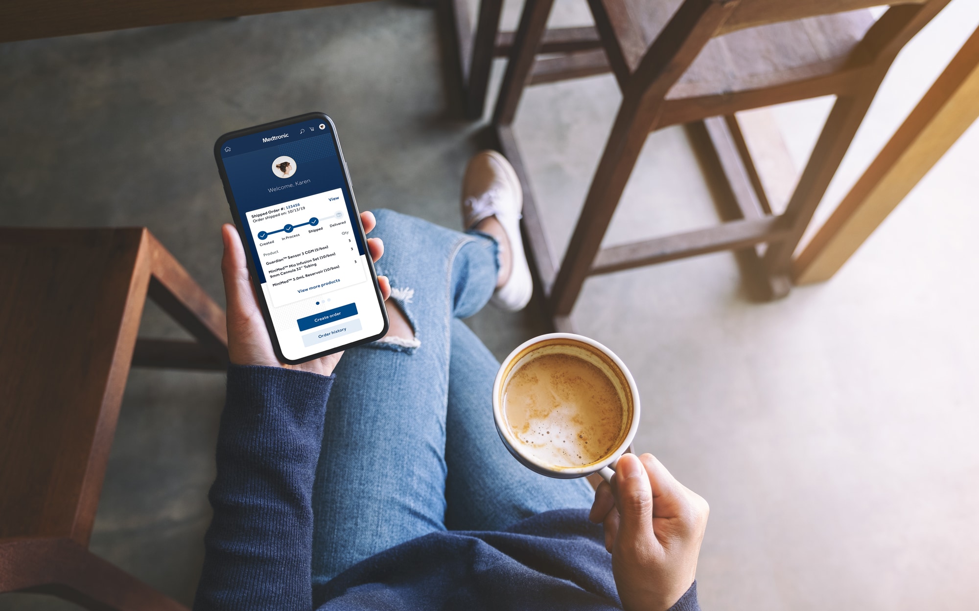 Person drinking a coffee and using a smartphone